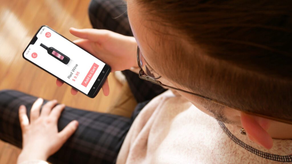 Customer orders wine on a phone through wine subscription software. 