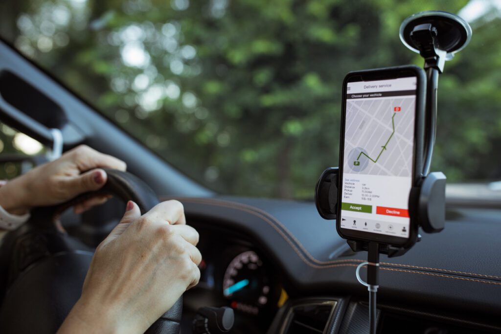 A delivery driver follows a map outlined through route optimization software on their phone. 